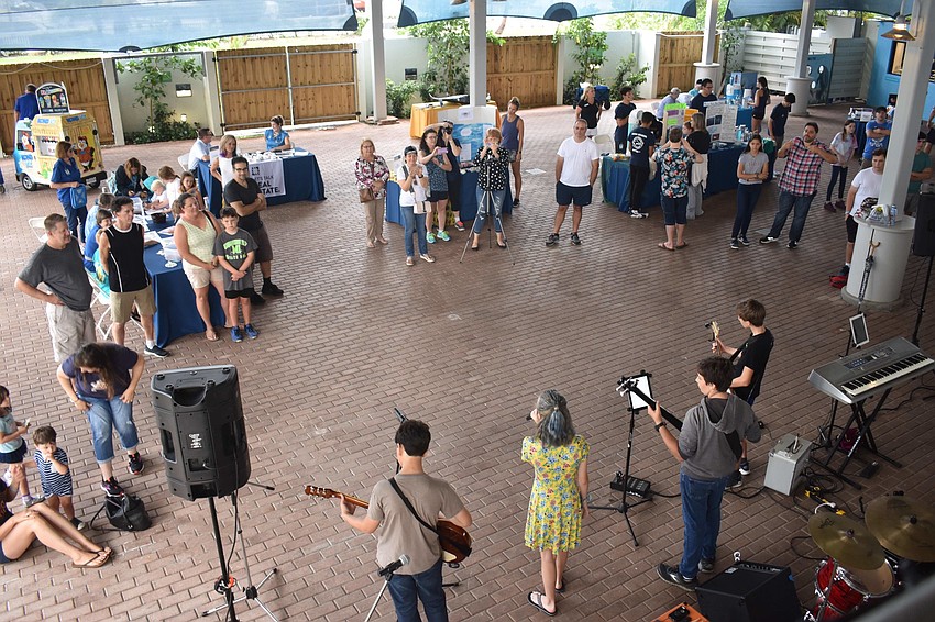 The crowd gathered under the roof, out of the rain for most of the morning.