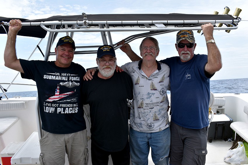 Former submariner James Jordan, former submariner Paul Lair, Jerry Elsenrath and  former submariner Bill Pretty watch from a separate boat.