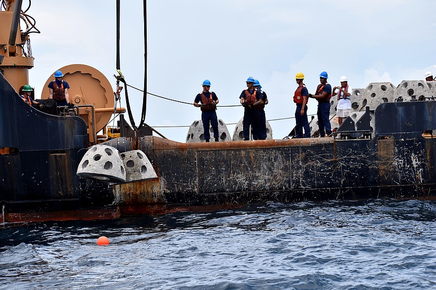 The first set of reef balls are lowered into the ocean.