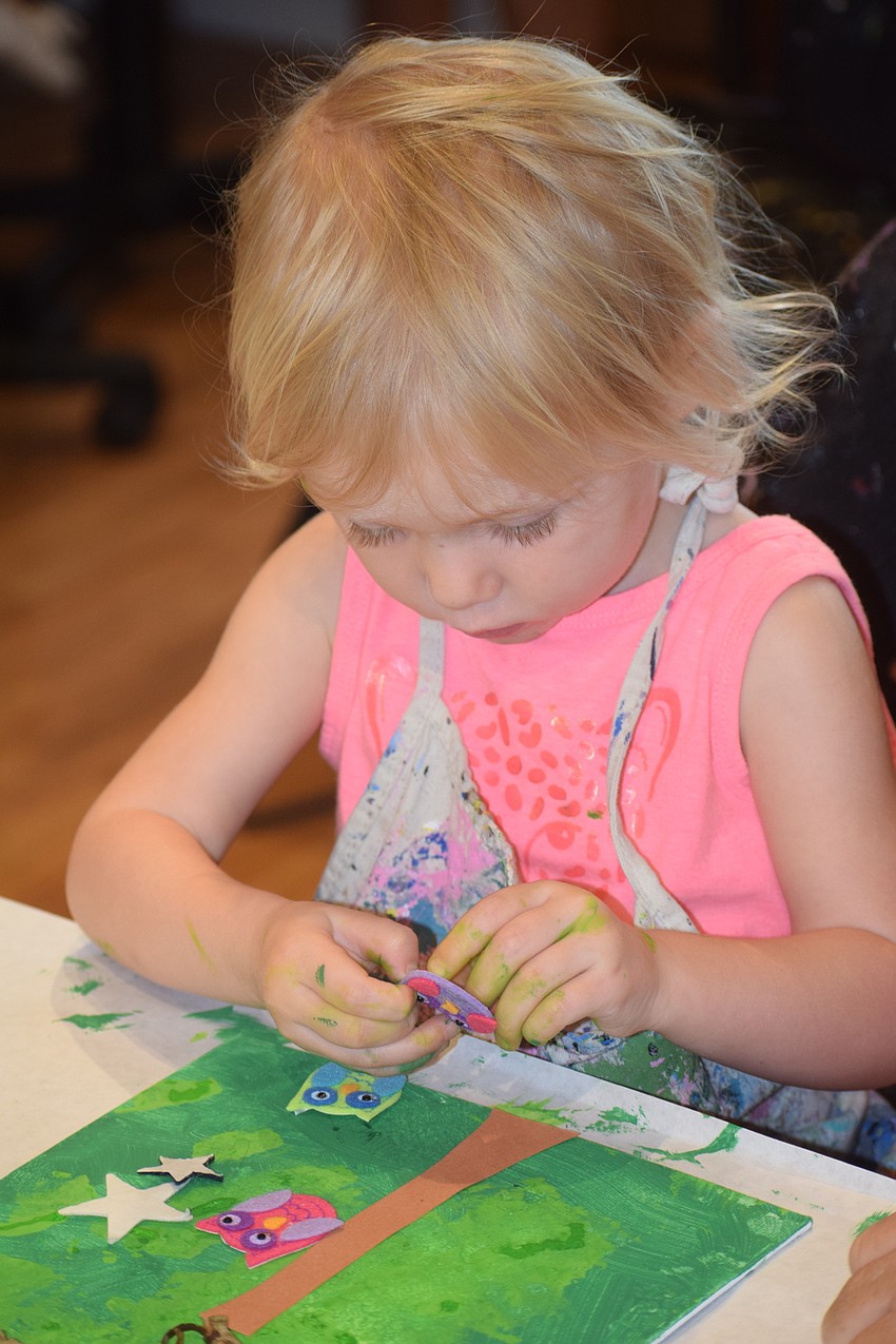 Lakewood Ranch 2-year-old Oliva Mikos puts the finishing touches on her painting.