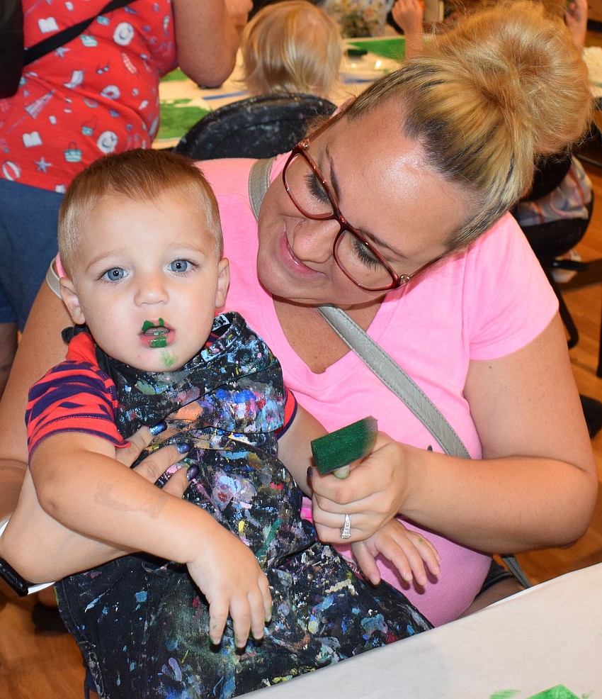 Sarasota 15-month-old Brandon Scott finds he has a real taste for art while his mom, Raychel Scott, gets ready to clean him off.