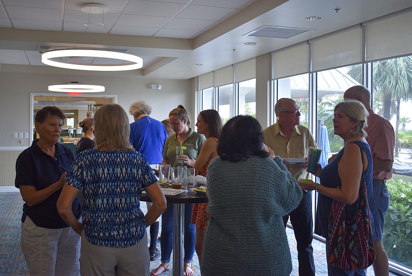 Volunteers of the Audubon Society chat during the celebration.