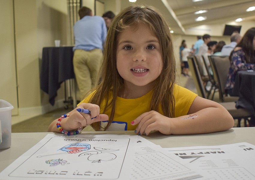 Lucy Wolff colors at the craft table.