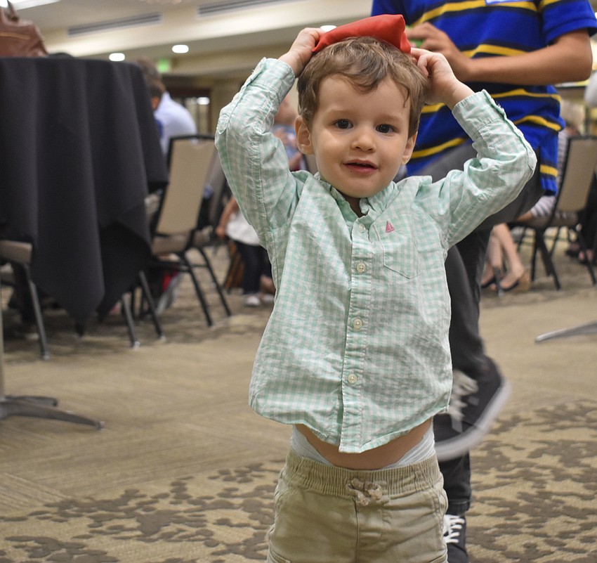 Robby Wagner, 2, smiles during his game of bean bag toss.