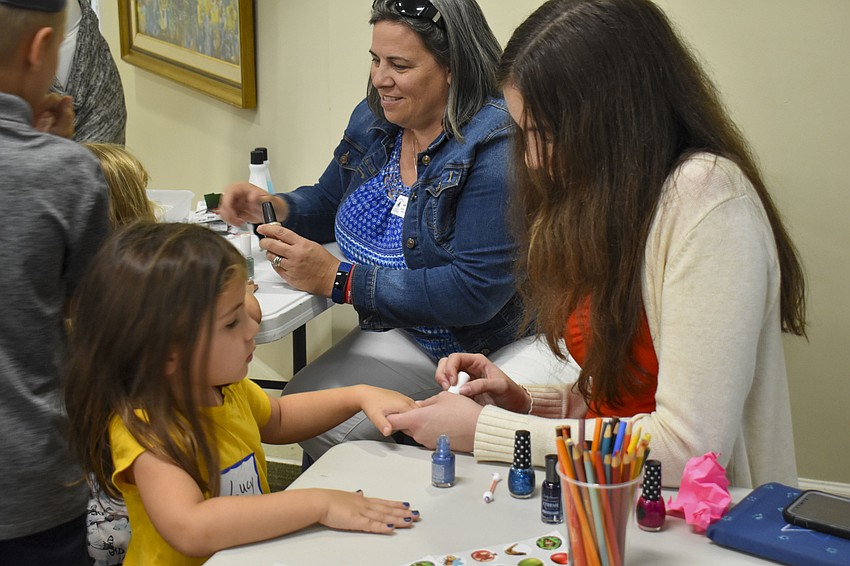 Megan Meese paints Lucy Wolfee's nails.