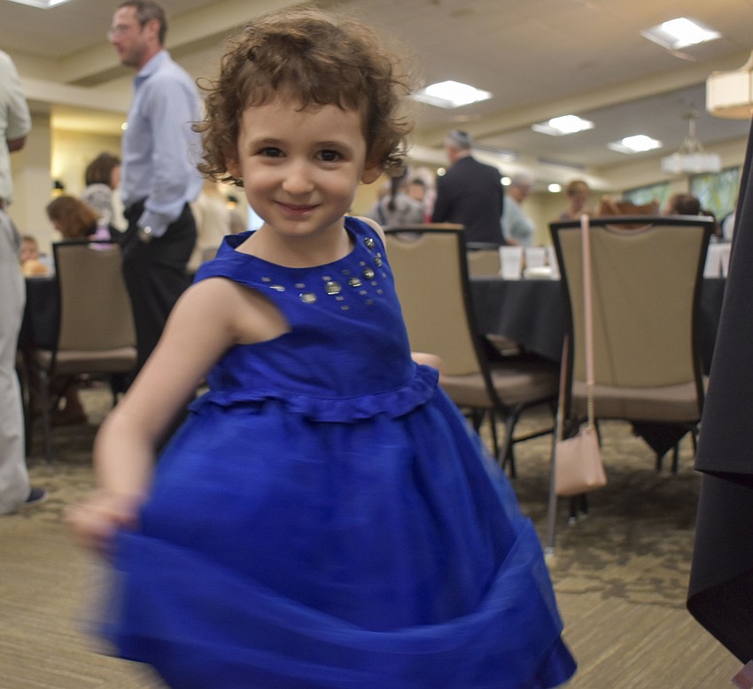 Samantha Wagner, 3, spins around the temple.