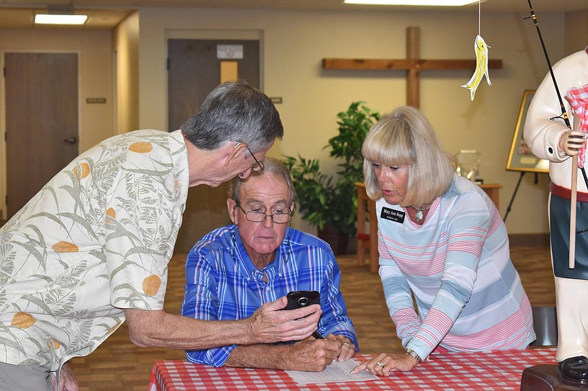 Michael Chester, Kirt and Mary Ann Bopp connect before the meal.