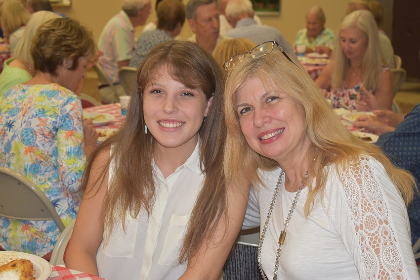 Alexa Lowrey and Michele de Lucca-Lowrey pose at the fish fry, days before Lowrey heads off to college for the first time.