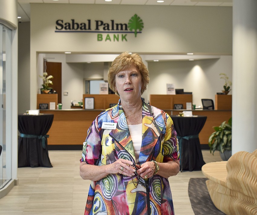 Kathy Collums, of Sabal Palm Bank, welcomes the group.