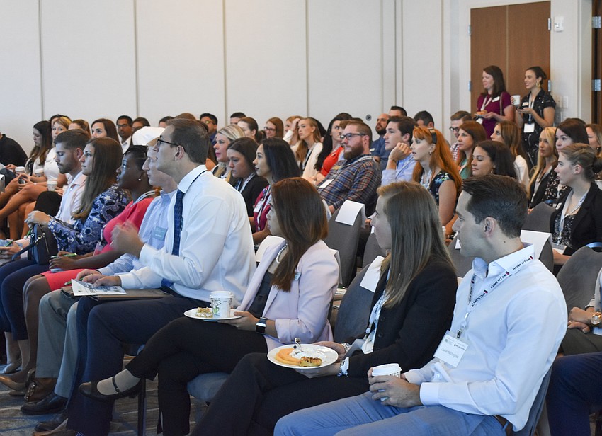 Young professionals from the Sarasota area listen as the summit welcome speech is given