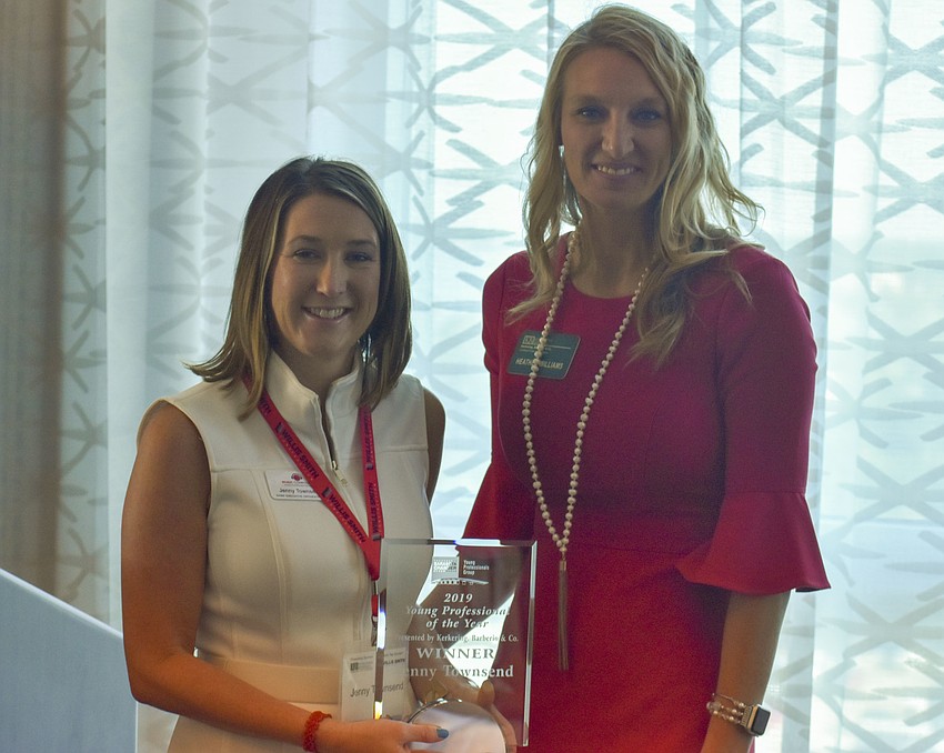 Heather Williams passes Jenny Townsend the 2019 Young Professional of the Year award.