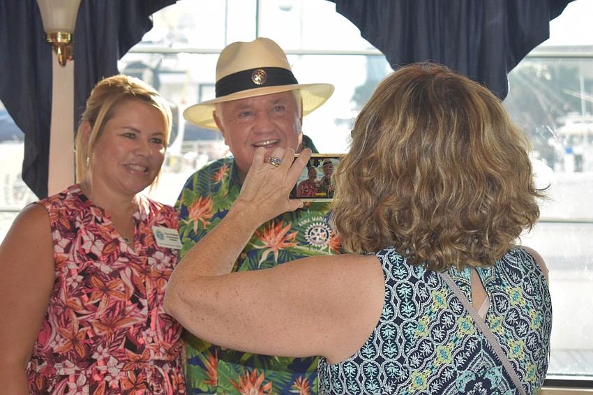 Sarah Brice snaps a photo of Tina Shelton and Dennis Sherman.