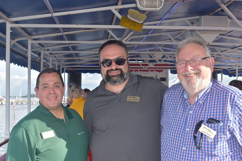Ron Vadez, Ramin Mesghali and Jack Dean pose on the upper deck.