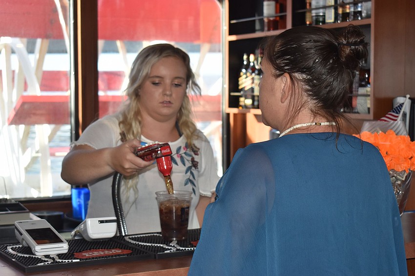 Lexie Deleon pours for Jennifer Thompson.