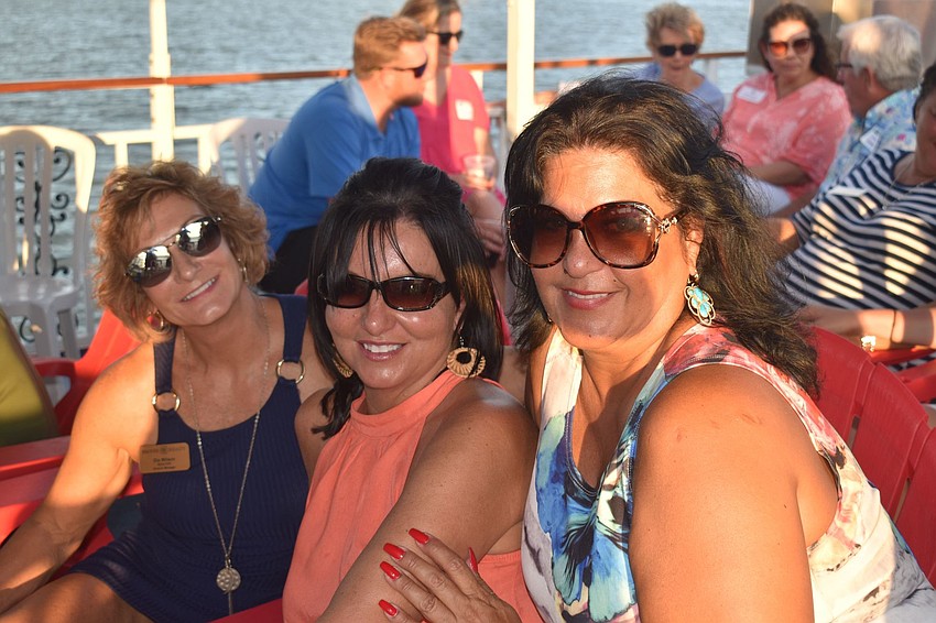 Rae Hayo, Mary Moore and Holly Sylvester pose in the sun.