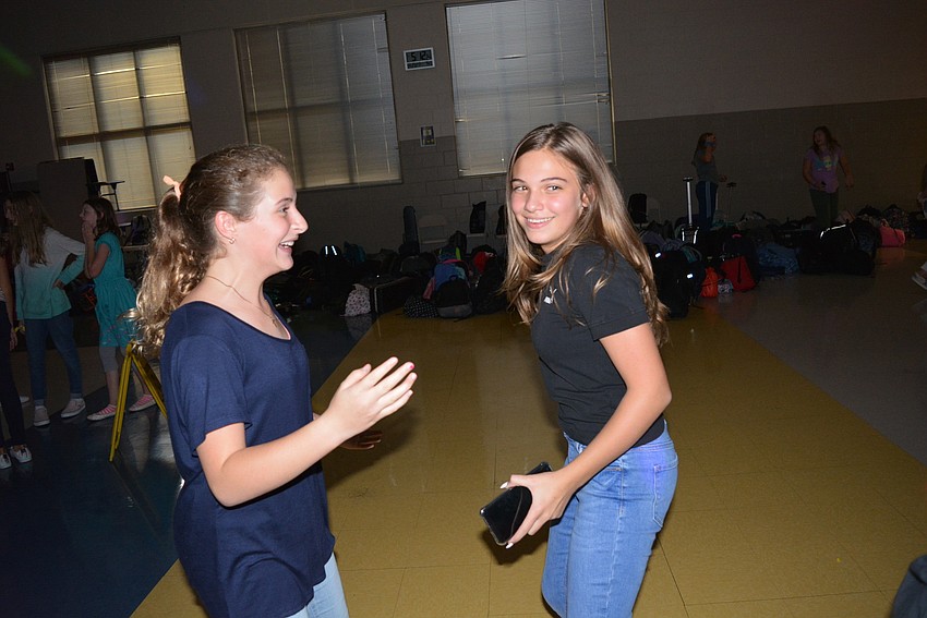 Lily Grigsby and Isabella Puco, both 12, dance to 