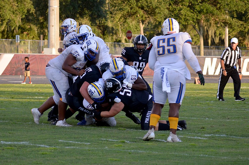Braden River senior Luke Reeves  (45) and junior Ethan Robb (58) stuff a Largo running back.