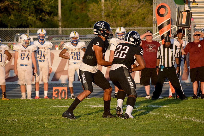 Braden River junior quarterback Shawqi Itraish hands the ball to sophomore running back Lavontae Youmans.