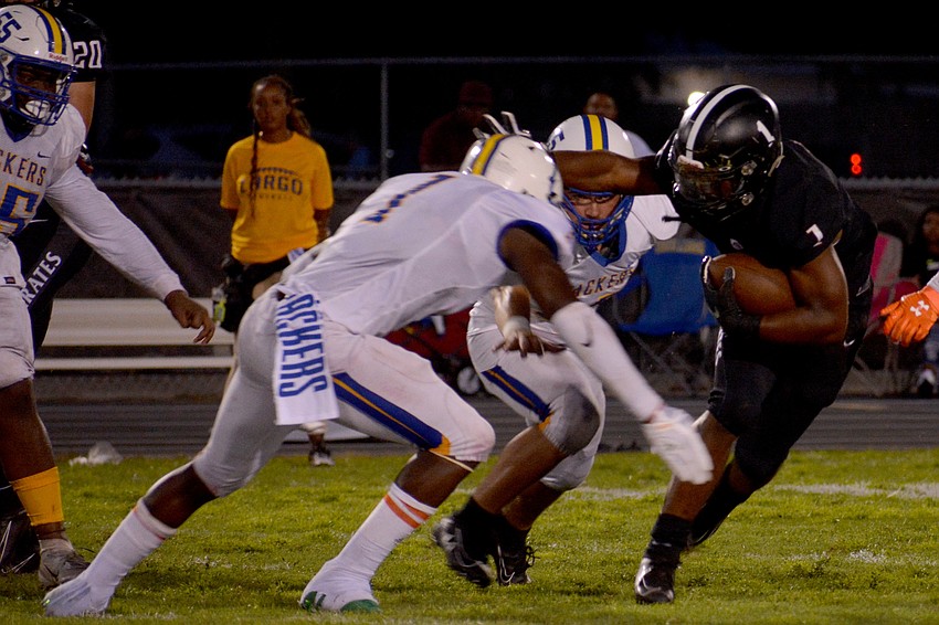 Braden River junior running back Jaheim Hodo stiff arms a Largo High defender.