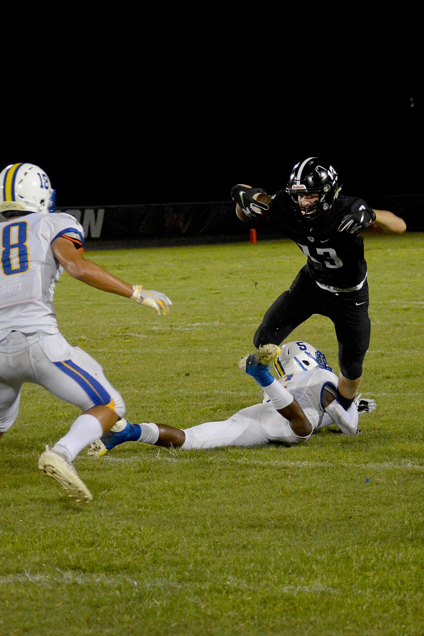 Braden River junior wideout Carson Goda leaps over a Largo defender after catching a screen pass.