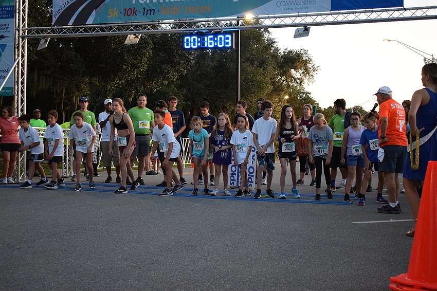 A group of 10 to 12 year olds prepare to take off during a kids race during the Fort Hamer Bridge Run.