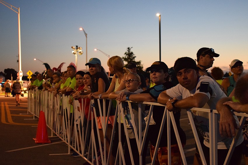 Family and friends line the side of the starting shoot to cheer for runners participating in the Fort Hamer Bridge Run.