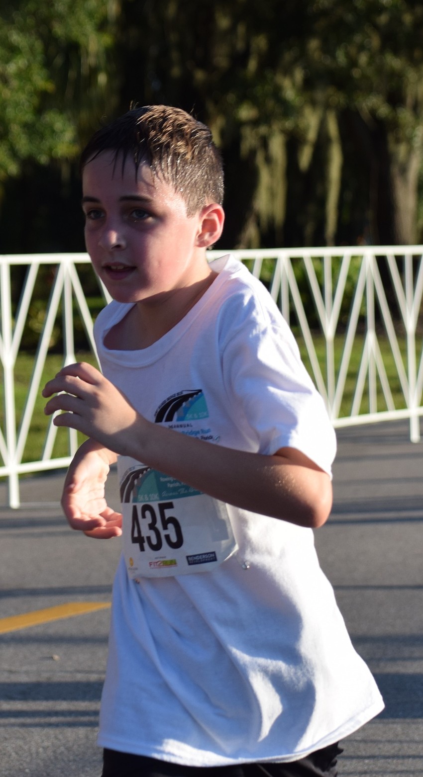 Bradenton resident Beckett Smith sprints toward the finish line during the Fort Hamer Bridge Run Saturday.