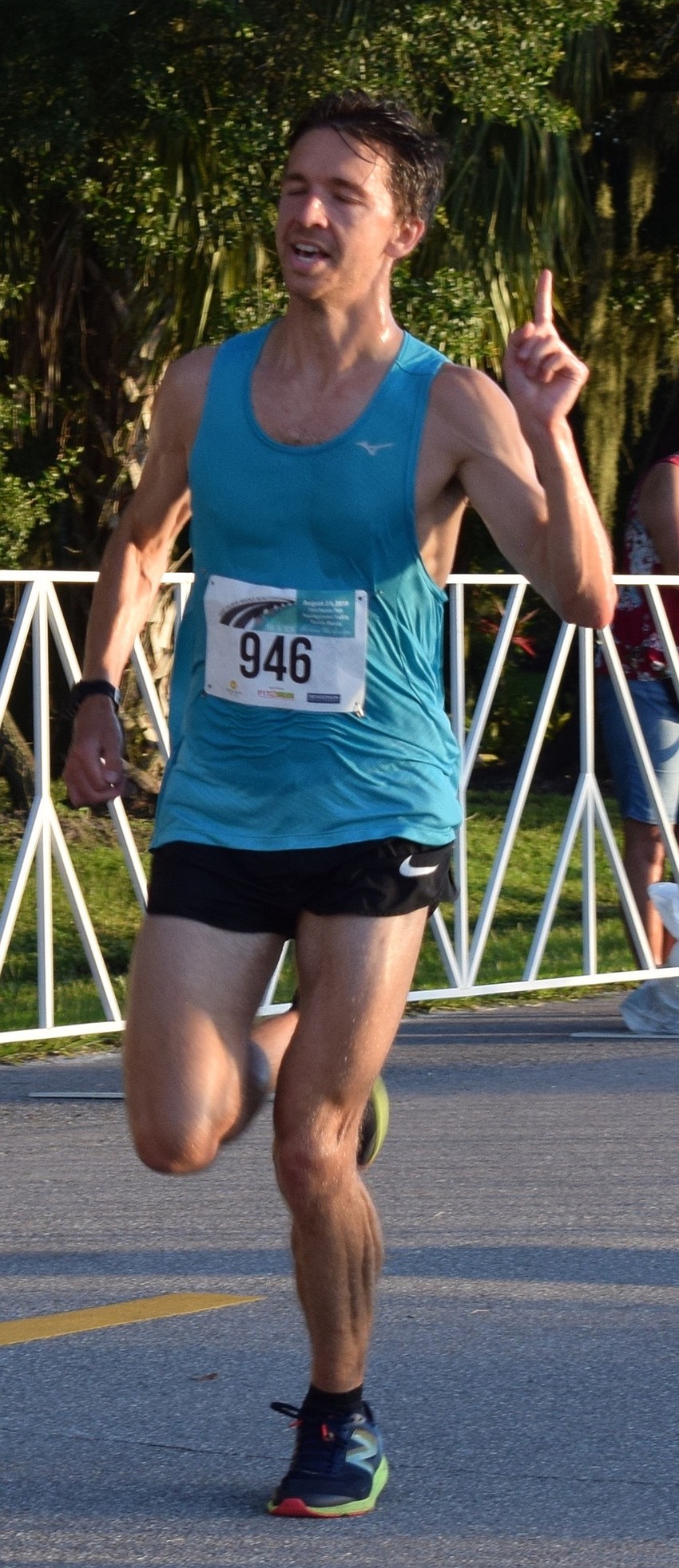 Alex Milne, of London, celebrates as he places first overall in the Fort Hamer Bridge Run 5K with a time of 15 minutes and 45 seconds.