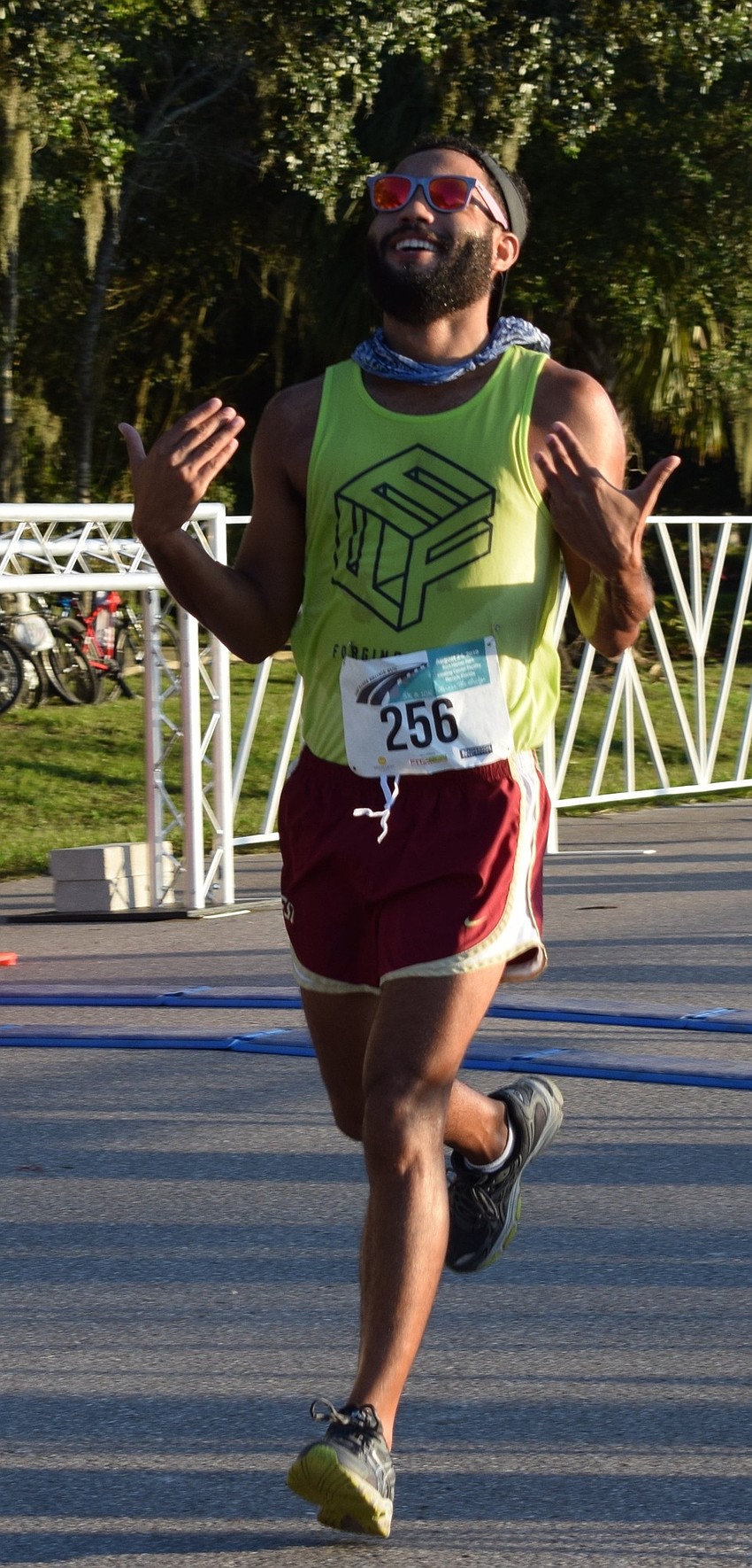 Parrish resident Jonathan Decker celebrates as he crosses the finish line of the Fort Hamer Bridge Run.