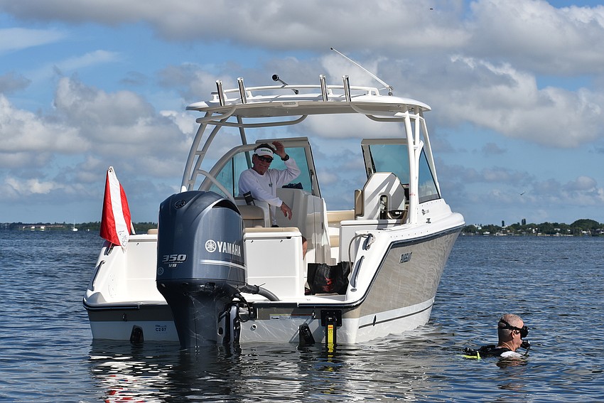 Captain Steve Martin and Al Jeffrey chat between water and deck.