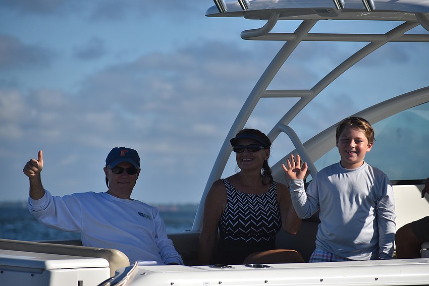 Jay Brady and Teresa and Tripp Lorentz relax on-deck before diving in.