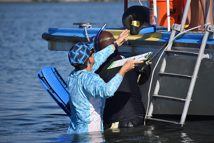 Alicia and Jeff Thomas lower themselves into the water.