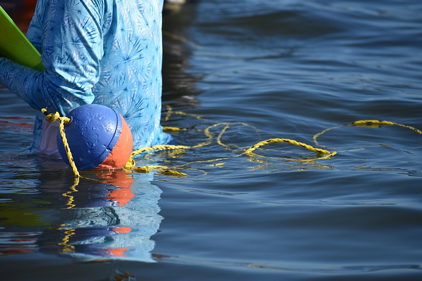 A line floats near Alicia Thomas to mark her area.