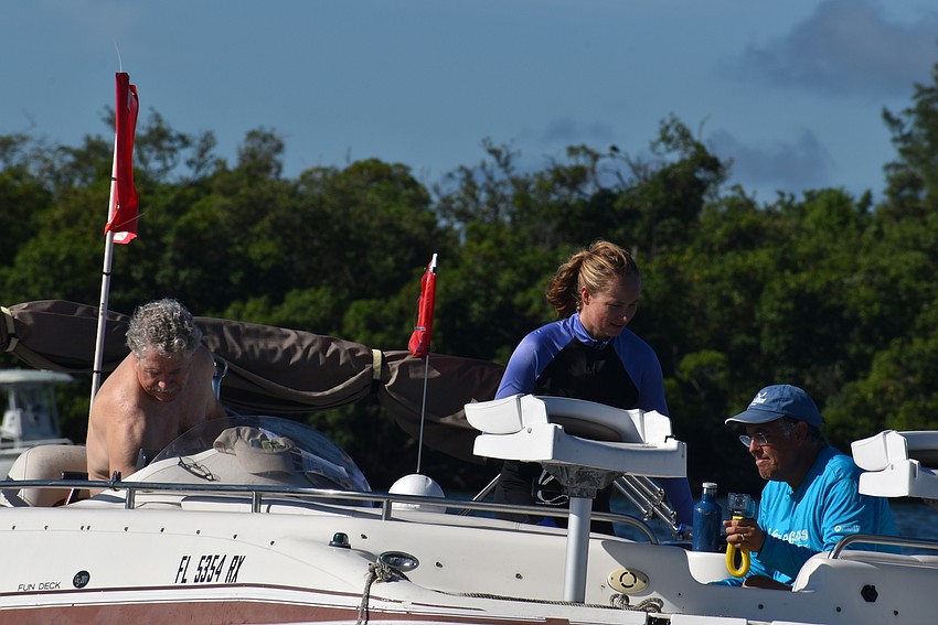 John Ryan, Martha Robinson and Ernesto Lasso de La Vega boat out to their spot.