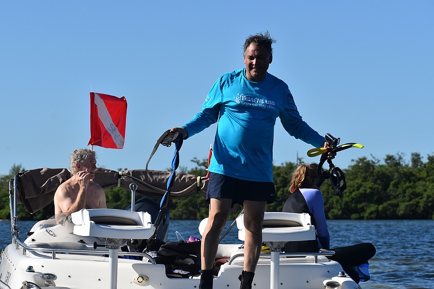 Ernesto Lasso de La Vega stands on deck of his boat.