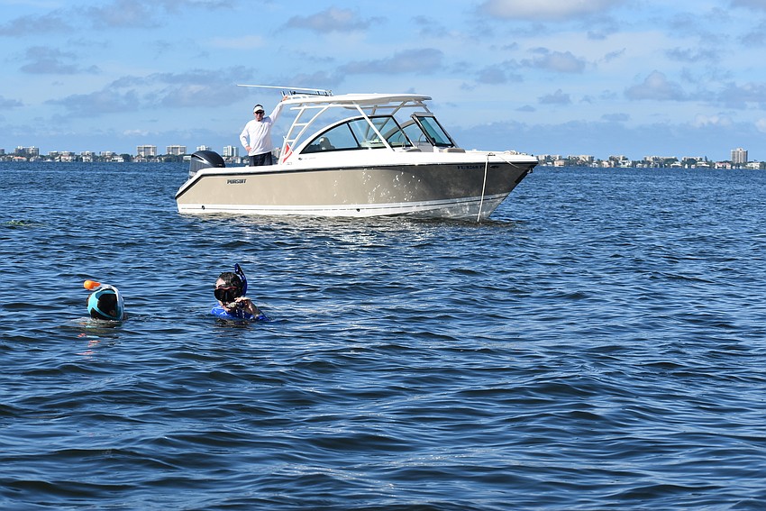 Tripp Lorentz and Jay Brady hang out in the water near Steve Martin's boat.