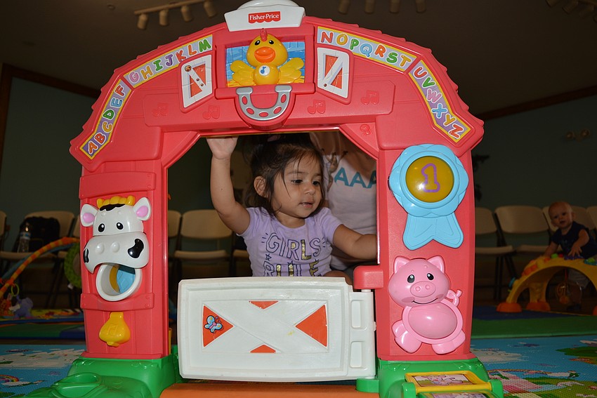 One-year-old East County resident Venus Gonzalez explores the toddler area with her mom, Cenya Moreno.