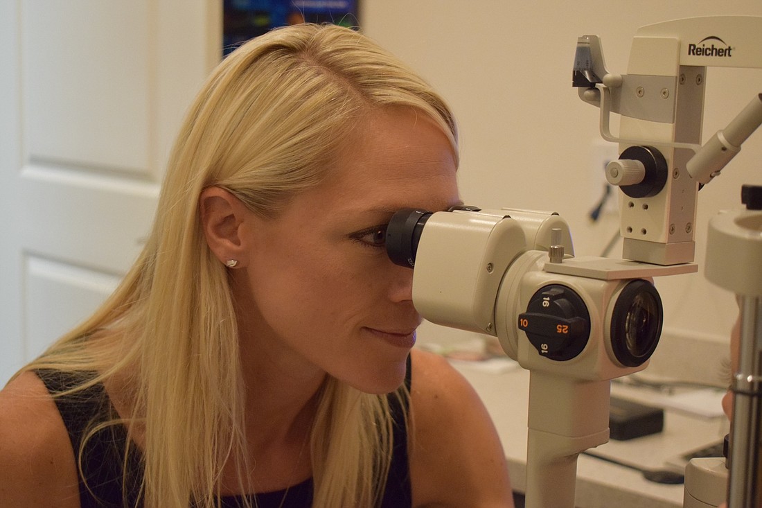 Lakewood Ranch optometrist Ashley Masuga conducts an eye exam. Masuga will be conducting dozens of eye exams as volunteer at the annual RAM clinic at Manatee Technical College in October.