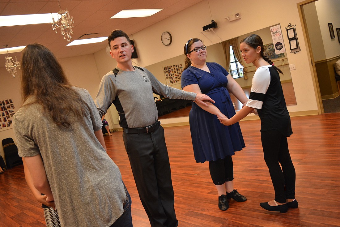 Ballroom dancing instructor Colton Gannon leads Dynasty Stars Program dancers, including Bryanna Schmidt (back right) and Sophia Slaughter (front right) in the tango.