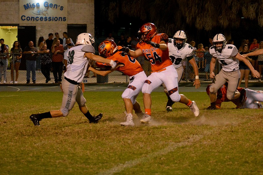 Lakewood Ranch senior Dylan Bennett (18) stops Lemon Bay quarterback Jason Hogan for no gain.