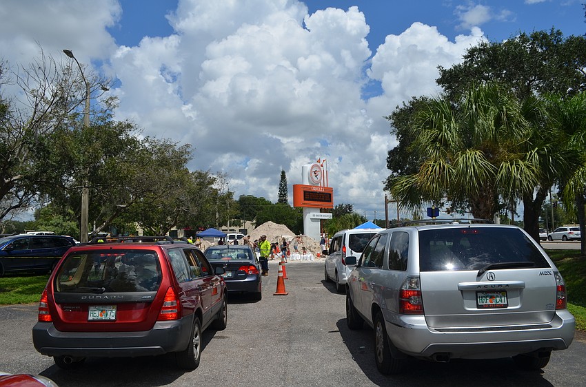 Cars lined up Friday afternoon at Ed Smith Stadium as residents waited for their opportunity to fill sandbags ahead of Hurricane Dorian.