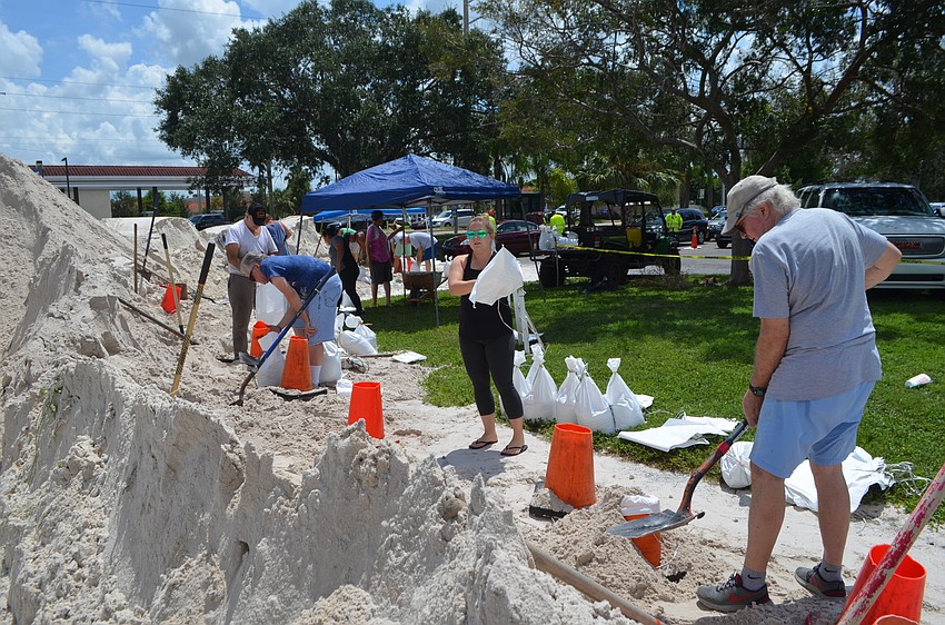 A large pile of sand sits in the Ed Smith Stadium parking lot as part of the sandbag assembly process.