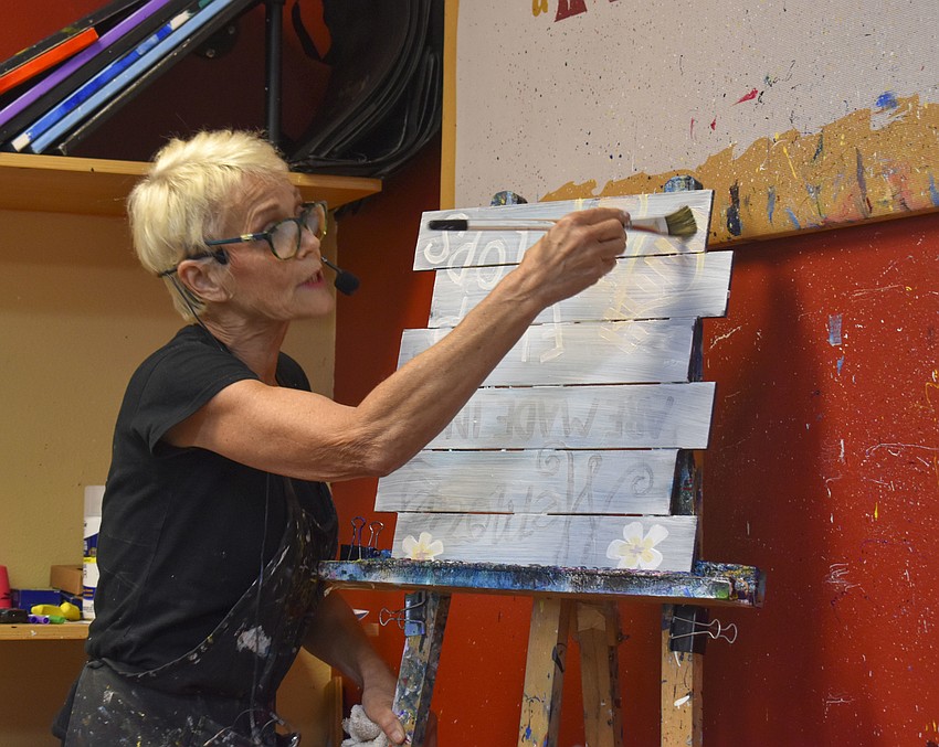 Connie Hanisch delivers directions and jokes to the painters.