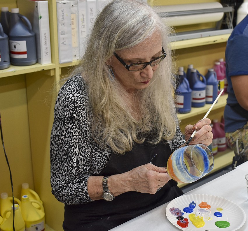 Roberta Caldwell chooses to paint the Colorado sunset on her wine glass instead of a koi fish.
