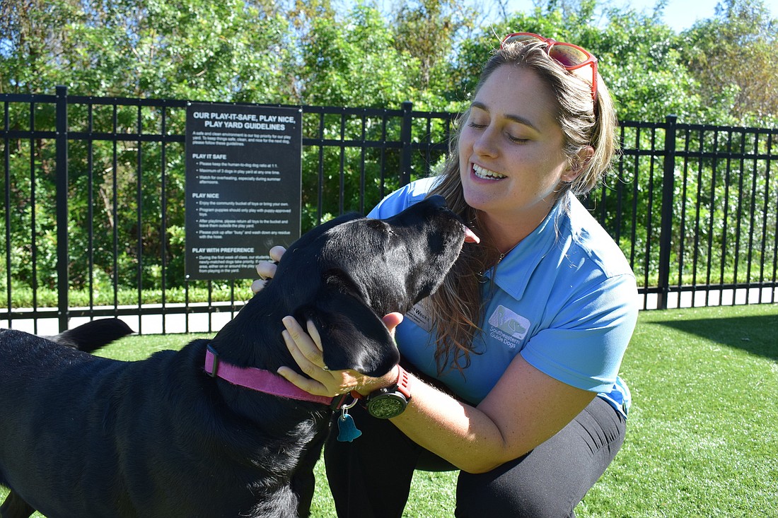 Rachel Weeks and Plum take a break on the Southeastern Guide Dog campus.