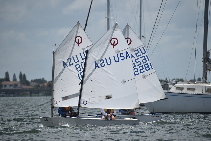 Three sailboats take to the bay.
