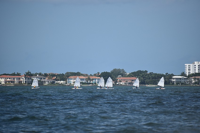 Boats line up on the horizon.