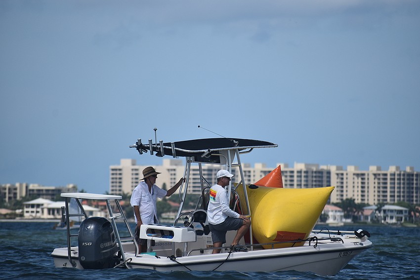 A safety boat heads out.