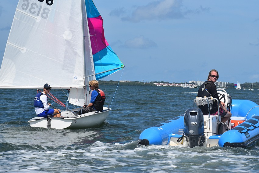 Evan Thomas and Kuno Posh figure out their boat while Quenton Chafee is nearby.