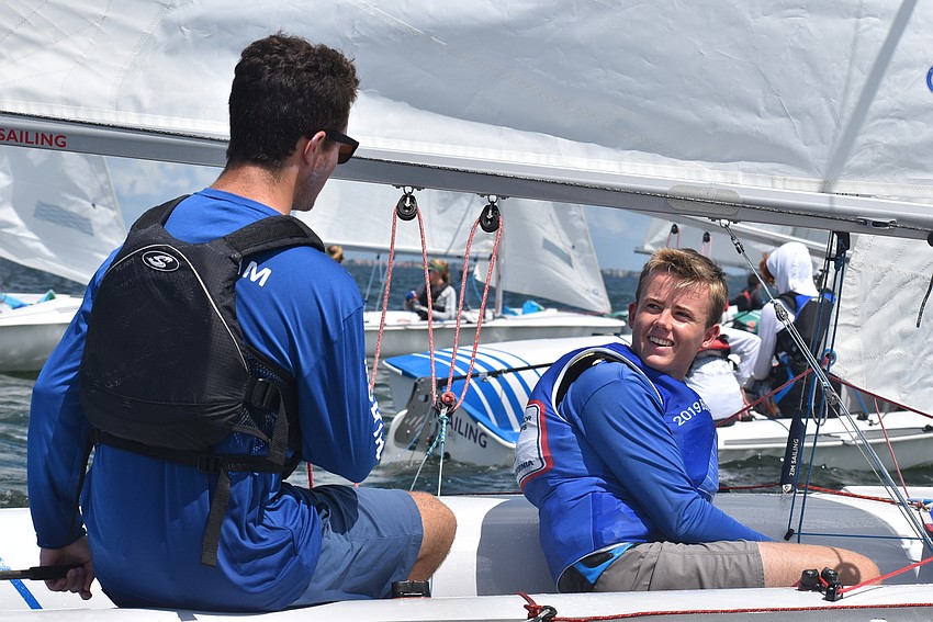 Camden Sullivan and Cooper Delbridge chat on their boat.